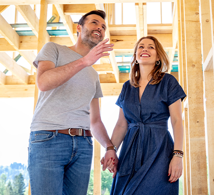 couple looking at their home under construction