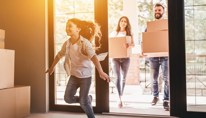 family moving boxes into a home