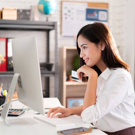woman with credit card on computer