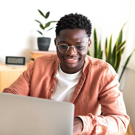 Man in front of laptop.