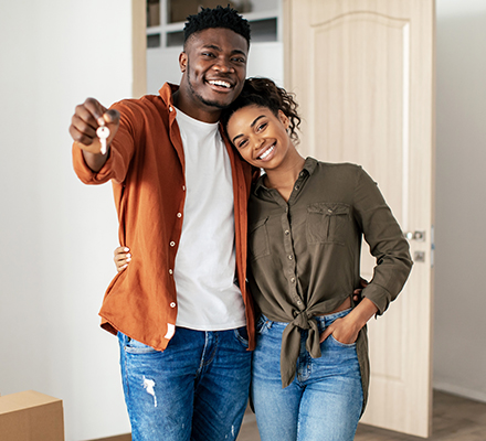 young couple in their new home holding keys
