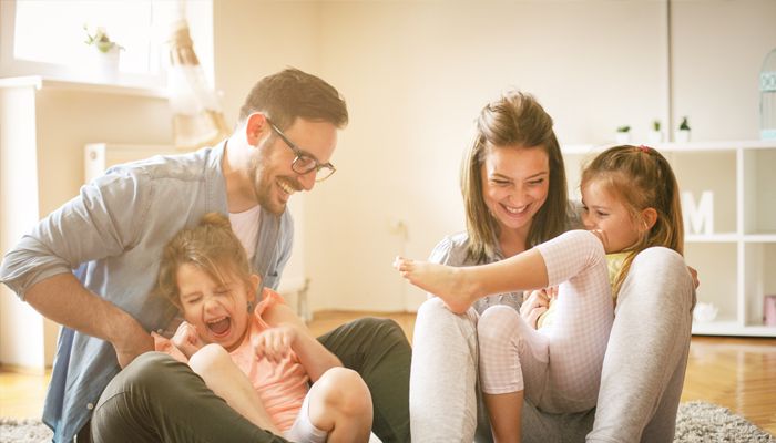 family smiling in a home