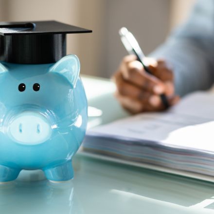 piggy bank wearing graduation hat