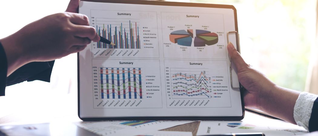 hands holding report of graphs