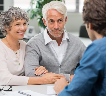 senior couple talking to financial advisor